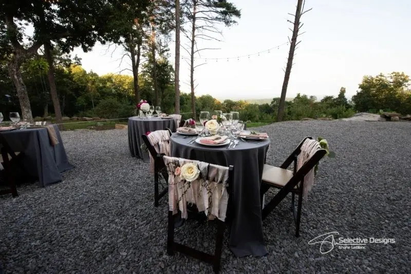 A table set up for two with chairs and plates.