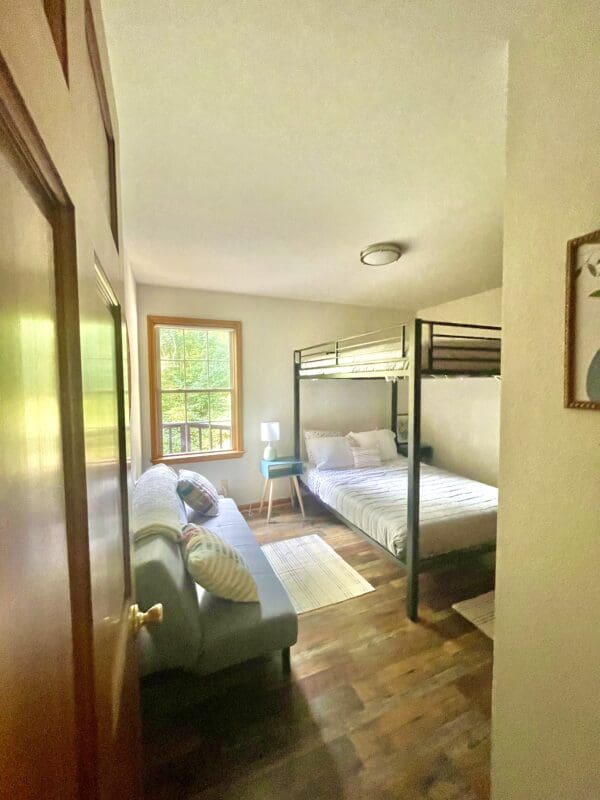 A room with two beds and a couch.